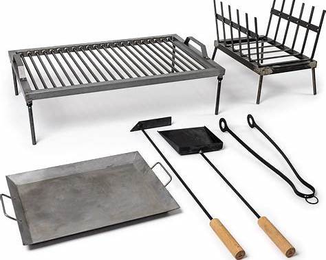 Argentinian parrilla grill set with metal grate, firebox, tongs, and spatula used for traditional asado cooking. Argentinian parrilla grill set with metal grate, firebox, tongs, and spatula used for traditional asado cooking.