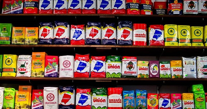 Different brands of yerba mate packages on a supermarket shelf